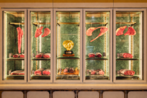 Dry-aged beef display at Beefbar Limassol, showcasing premium steak cuts inside Amara Hotel